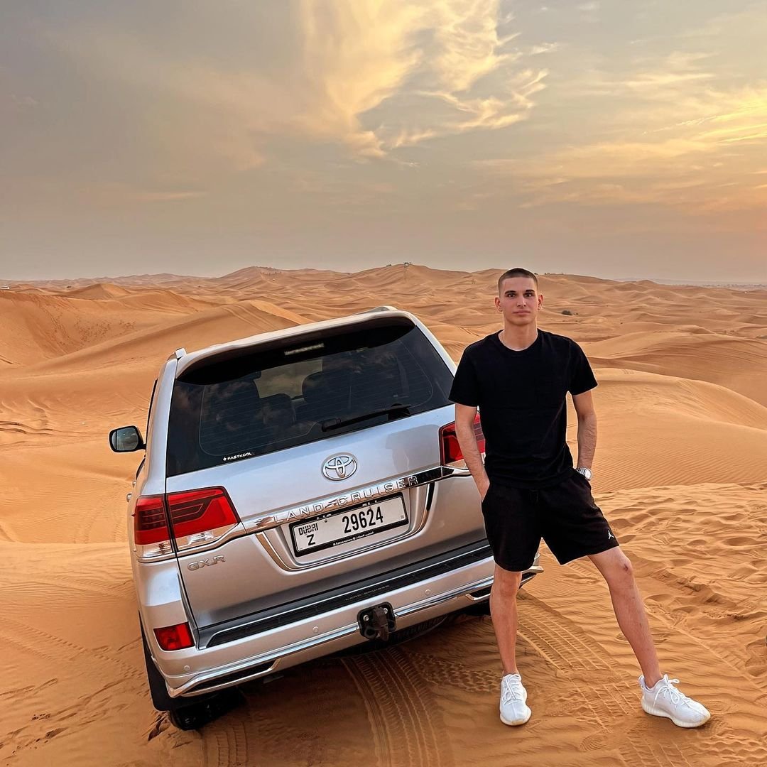 a-man-standing-in-desert-with-Landcruiser